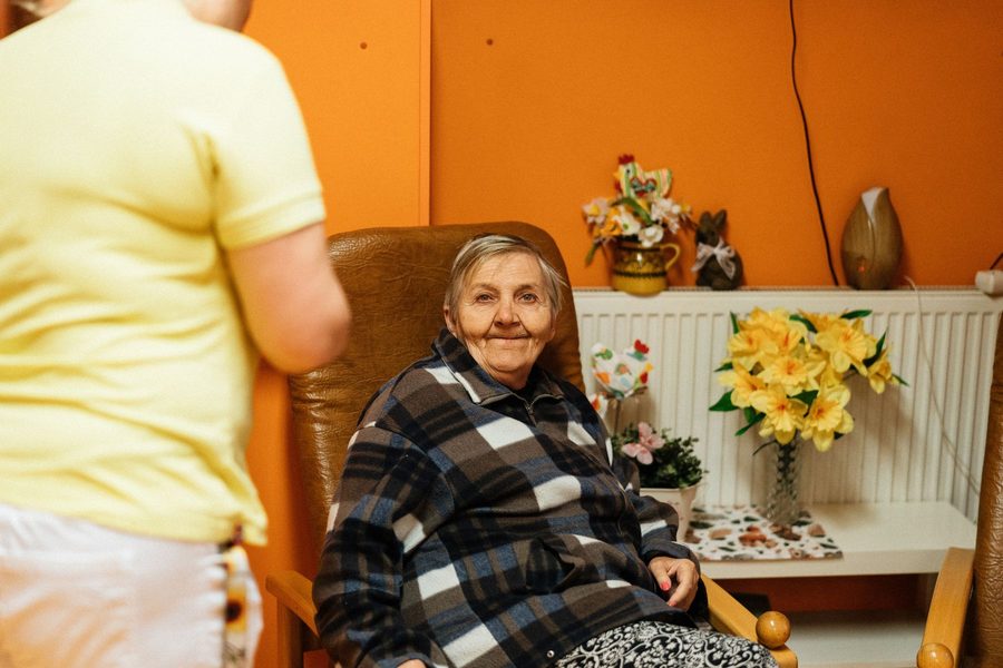 A resident and carer in a sitting room at Ashcombe House